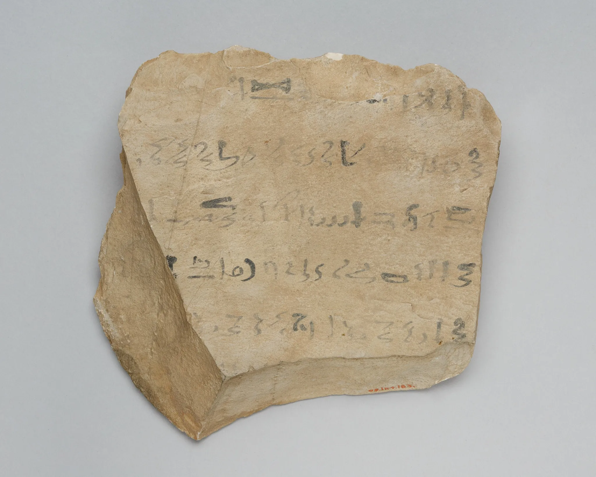 Real photo: Real practice writing from a scribe school: hieratic signs on a flake of stone (The Metropolitan Museum of Art).